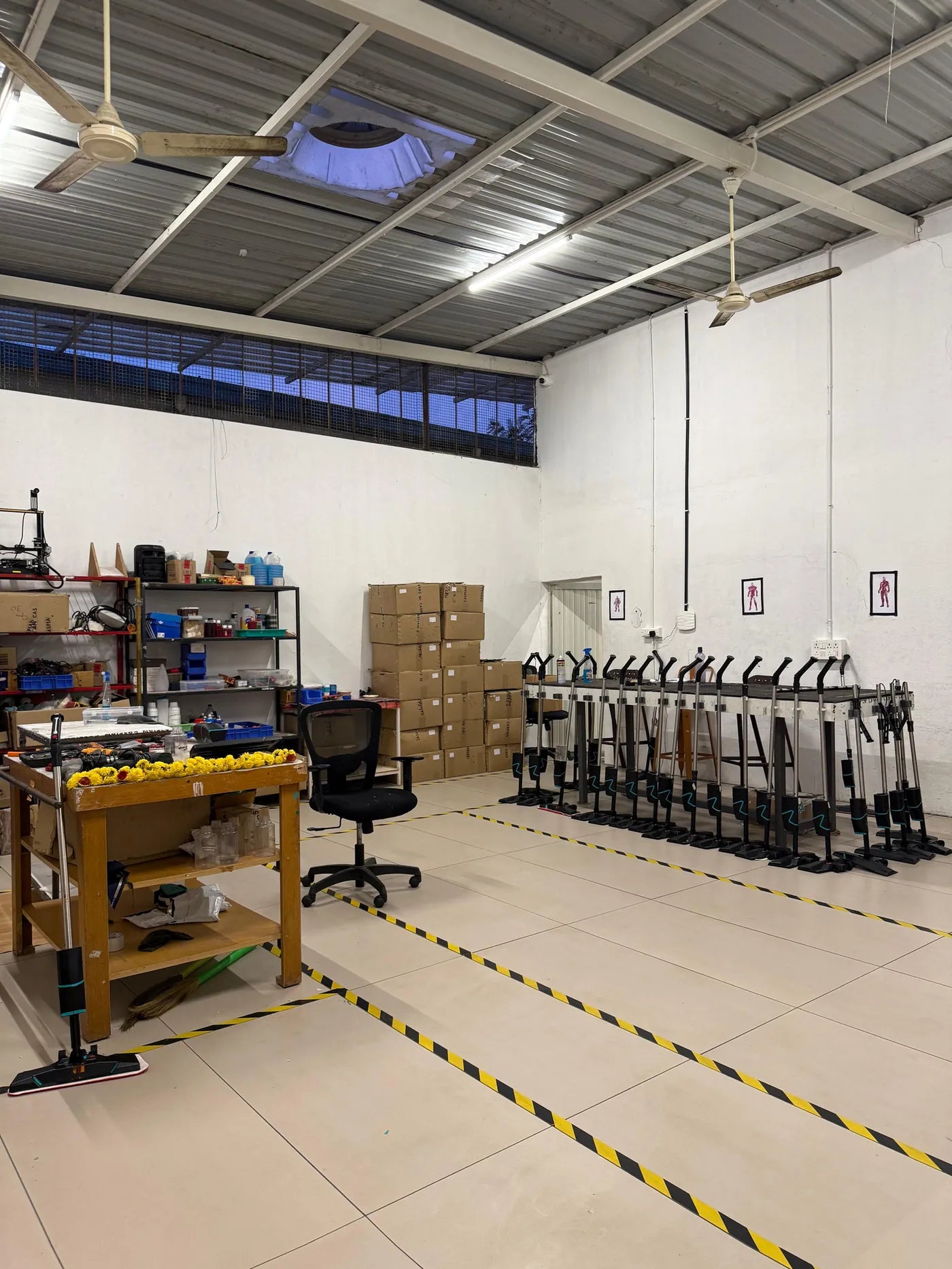 The Caspian production floor in Mysuru, with marked lanes and a row of SmartMops