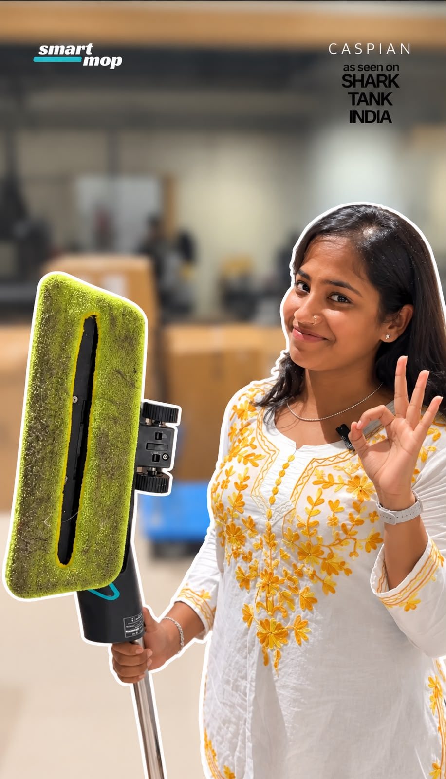 A Smart Mop pad covered in dirt after one clean, held up next to a smiling customer