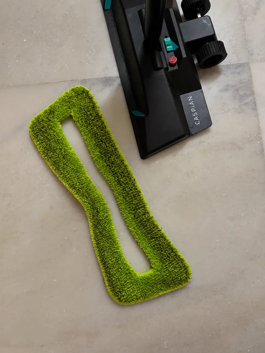 A used green SmartMop microfiber pad, dark with dirt, beside the SmartMop base