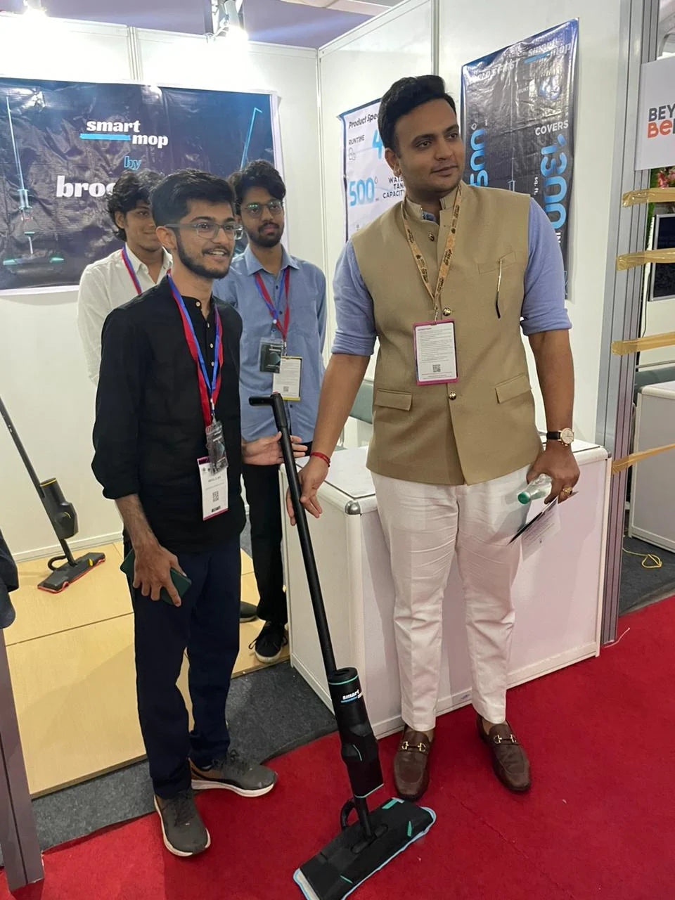 Mehul showing the SmartMop to a visitor at the Caspian stand at an expo